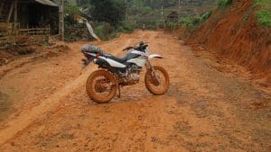Honda XR 150 on a really muddy road in North Vietnam