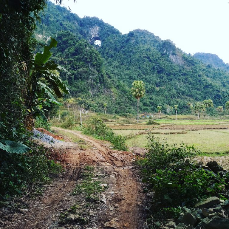 view of a dirt road leading to a cave just off the ql2 on the way to ha giang