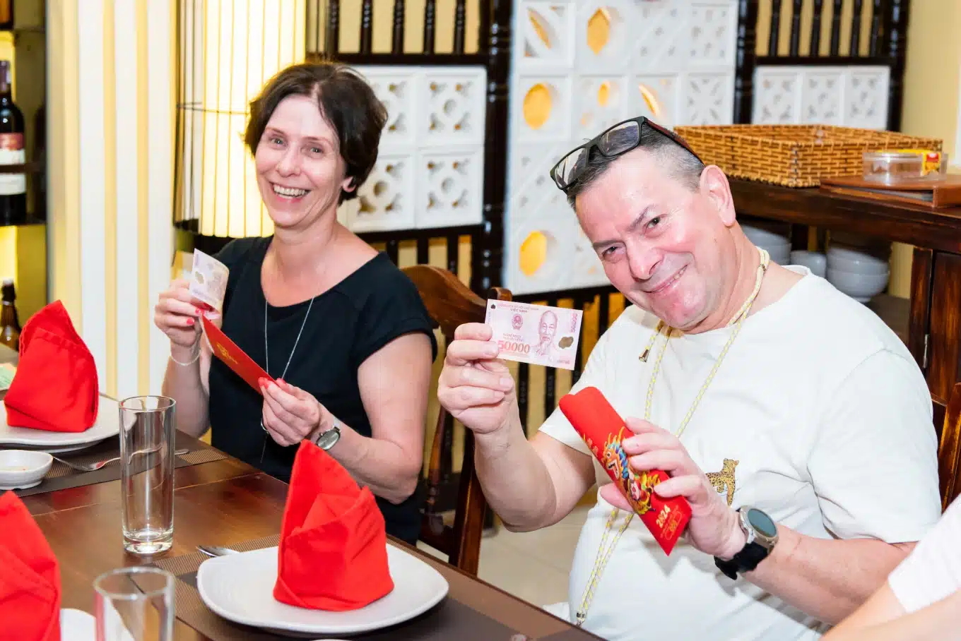 foreigners receive lucky mony li xi in small red envelopes