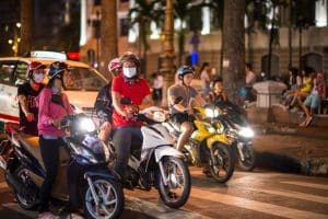 motorcyclists on a busy Vietnam street at night