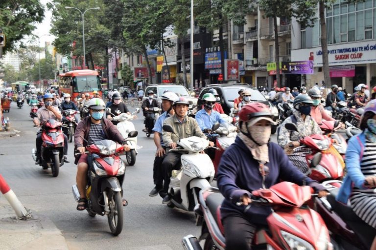 typical Vietnamese traffic - a few cars and a lot of motorbikes
