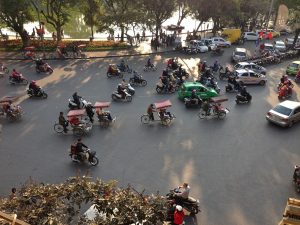 cyclo drivers heading past Hoan Kiem Lake