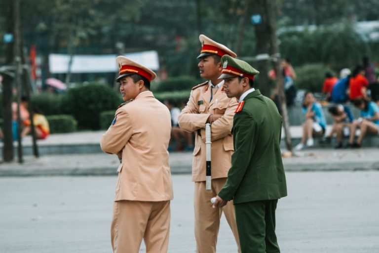 police standing at a busy intersection in North Vietnam