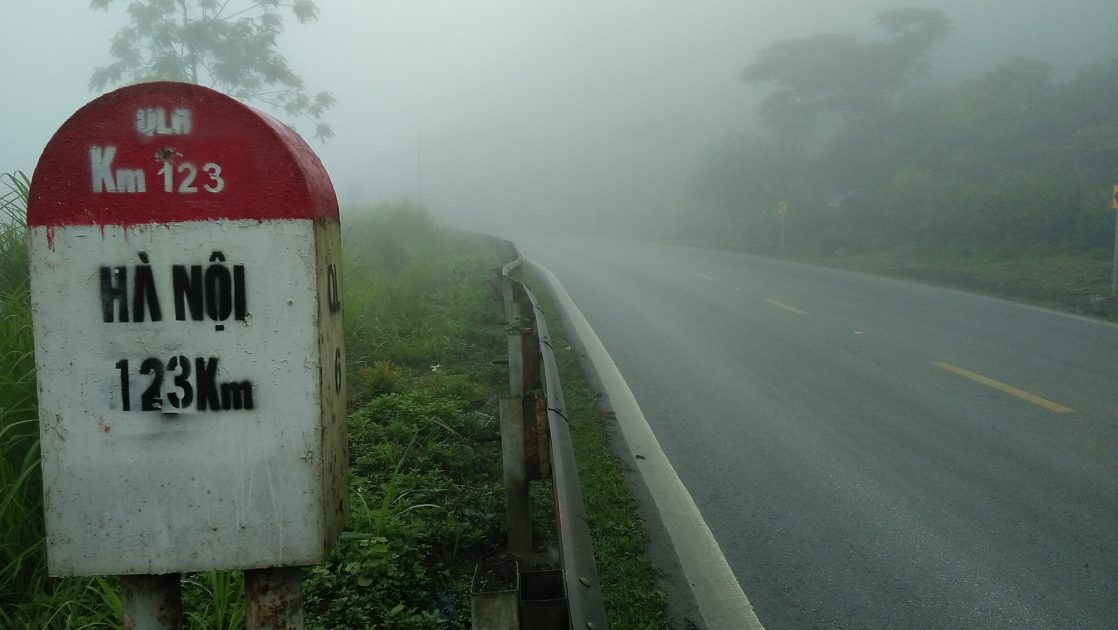 a distance marker on the road back to Hanoi