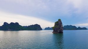 a big rock jutting out of the water in Ha Long Bay, North Vietnam