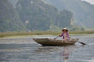 a Boat Woman in Van Long Nature Reserve