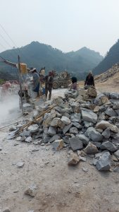 road construction workers on a small roadside quarry