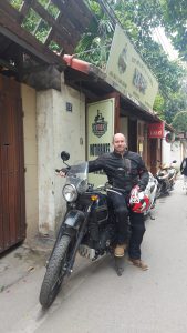 danny on the royal enfield himalayan outside the hanoi shop