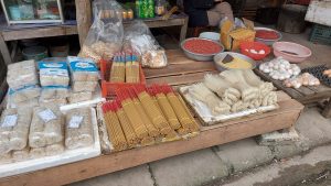 Incense, dried noodles, peanuts and eggs for sale at Bac Son Market