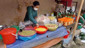 woman selling dried pulses and honey in bac son market, lang son