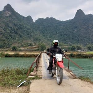 Danny, owner of Rentabike Vietnam, crossing a bridge in Cao Bang