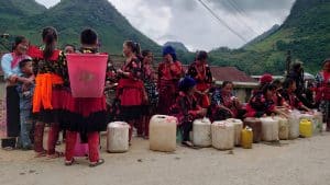 a group of local ethnic women selling corn or rice liquor