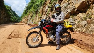 Honda XR rider on dirt section of the Hoa Binh lakeside road on a Vietnam Motorcycle tour