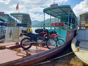 motorcycles on the ferry across the river