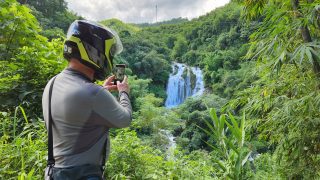 taking a photo of the Go Lao Waterfall