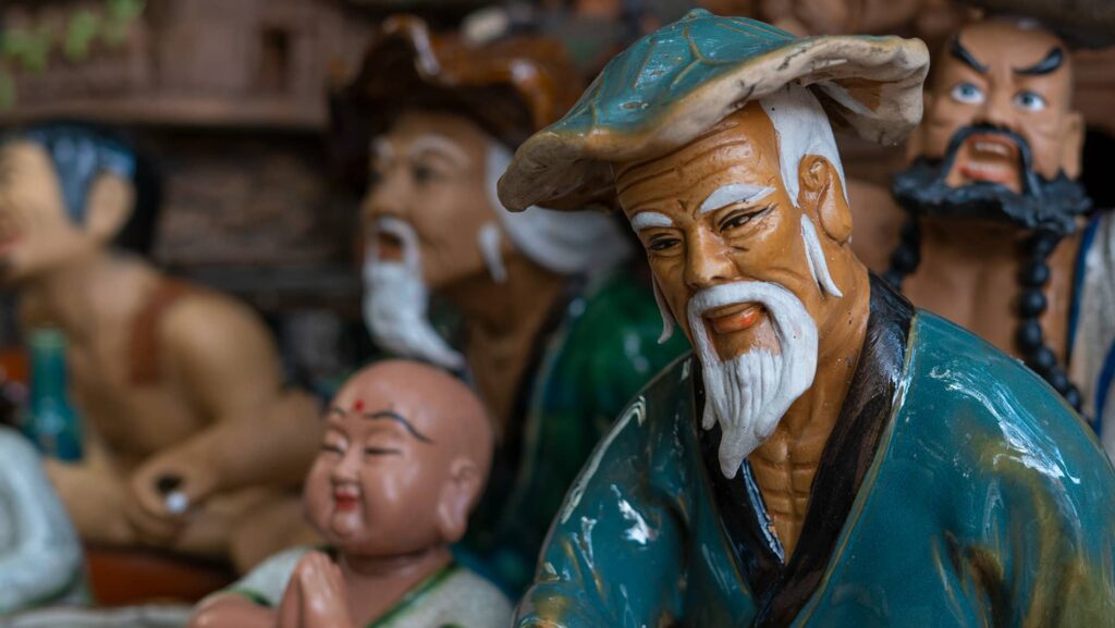 a smiling old man made of clay in Bat Trang