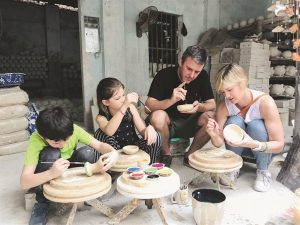 a family having fun making their own pots