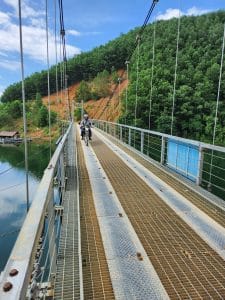 Crossing the suspension bridge on the thung nai road
