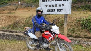 Honda XR150 at the border with the fence and china in the background