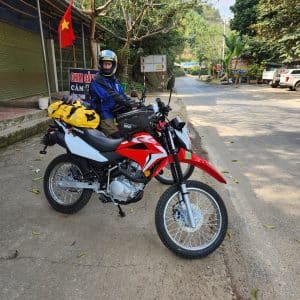 Two Honda XR150s and a rider outside a pho shop in Bac Kan on the way to ba be lake