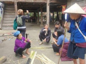 learning about basket weaving from local people in their home in ha giang