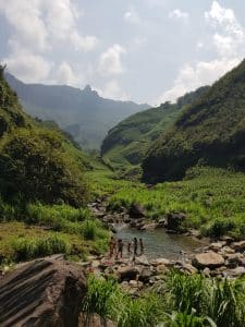children swimming in a small stream on a hot day in ha giang province