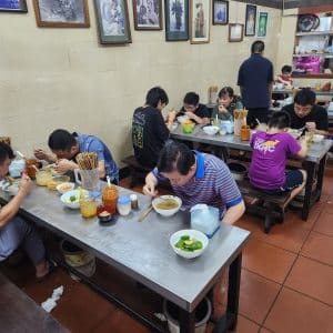 Happy customers chomping away on bowls of Pho in Pho Thin, Lo Duc St.