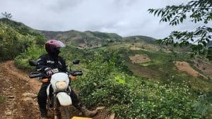 Rentabike Vietnam rider stops for a break on a muddy road up north