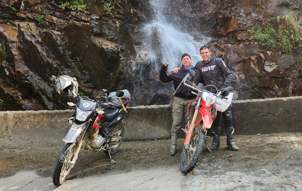 Tom and Danny on the Honda XR150 and the Honda CRF300 at a waterfall in Ha Giang