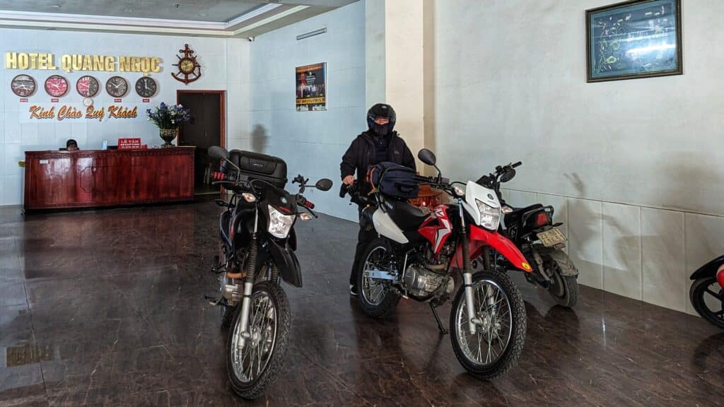 two honda xr150 parked in the lobby of a hotel in vietnam