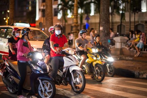 motorcyclists on a busy Vietnam street at night motorcyclists on a busy Vietnam street at night