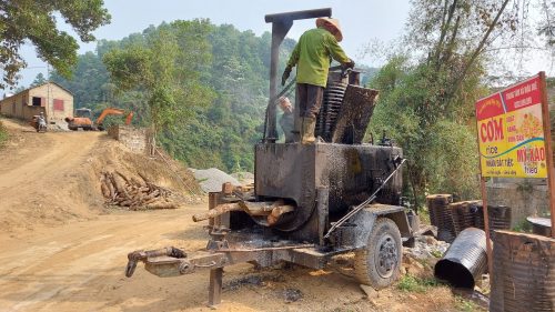 road construction workers heating bitumen for the road in ha giang