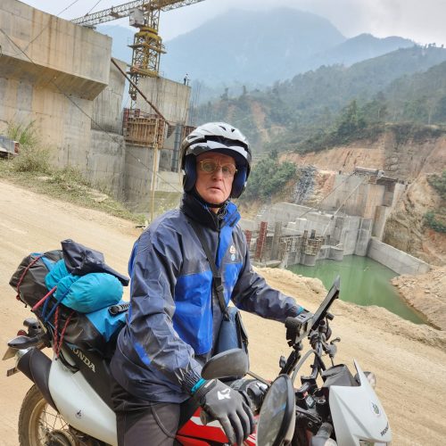 Paul Brooke driving the xr150 through a dam under construction in Hoang Su Phi