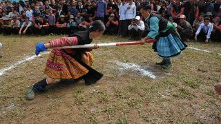 Hmong girls at a market playing traditional games Hmong girls at a market playing traditional games
