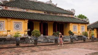 a tourist entering the temple in Hue