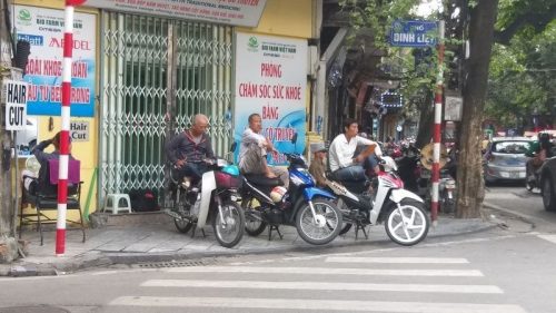 xe om (motorbike taxi) drivers waiting for fares in Hanoi's Old Quarter