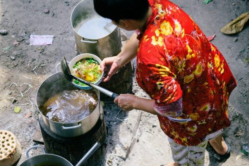 lady preparing food on the street in Vietnam