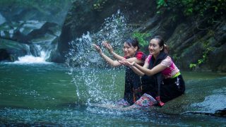 a couple of local women playing in the water at Thac Khe Kem