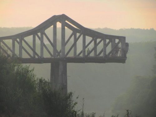 the haunting sight of a derelict bridge at dawn