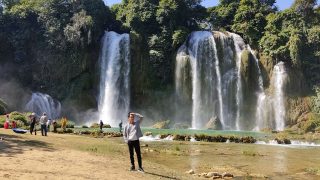 Ban Gioc waterfall with a young tourist posing